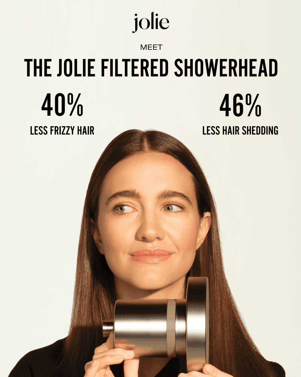 Woman holding Jolie filtered showerhead, promises less frizzy hair and less hair shedding.